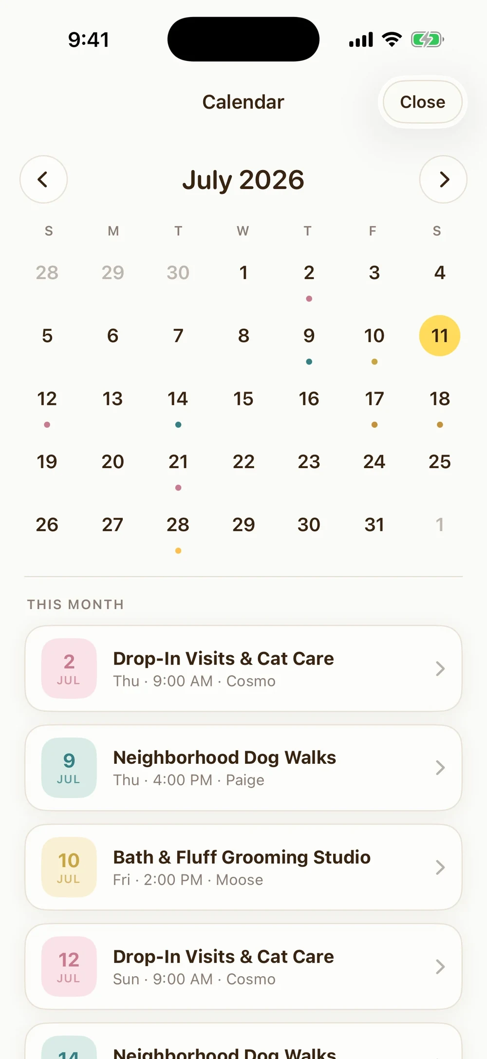 Pawprint calendar in a monthly view with bookings marked by color-coded service dots and a this-month agenda of upcoming bookings